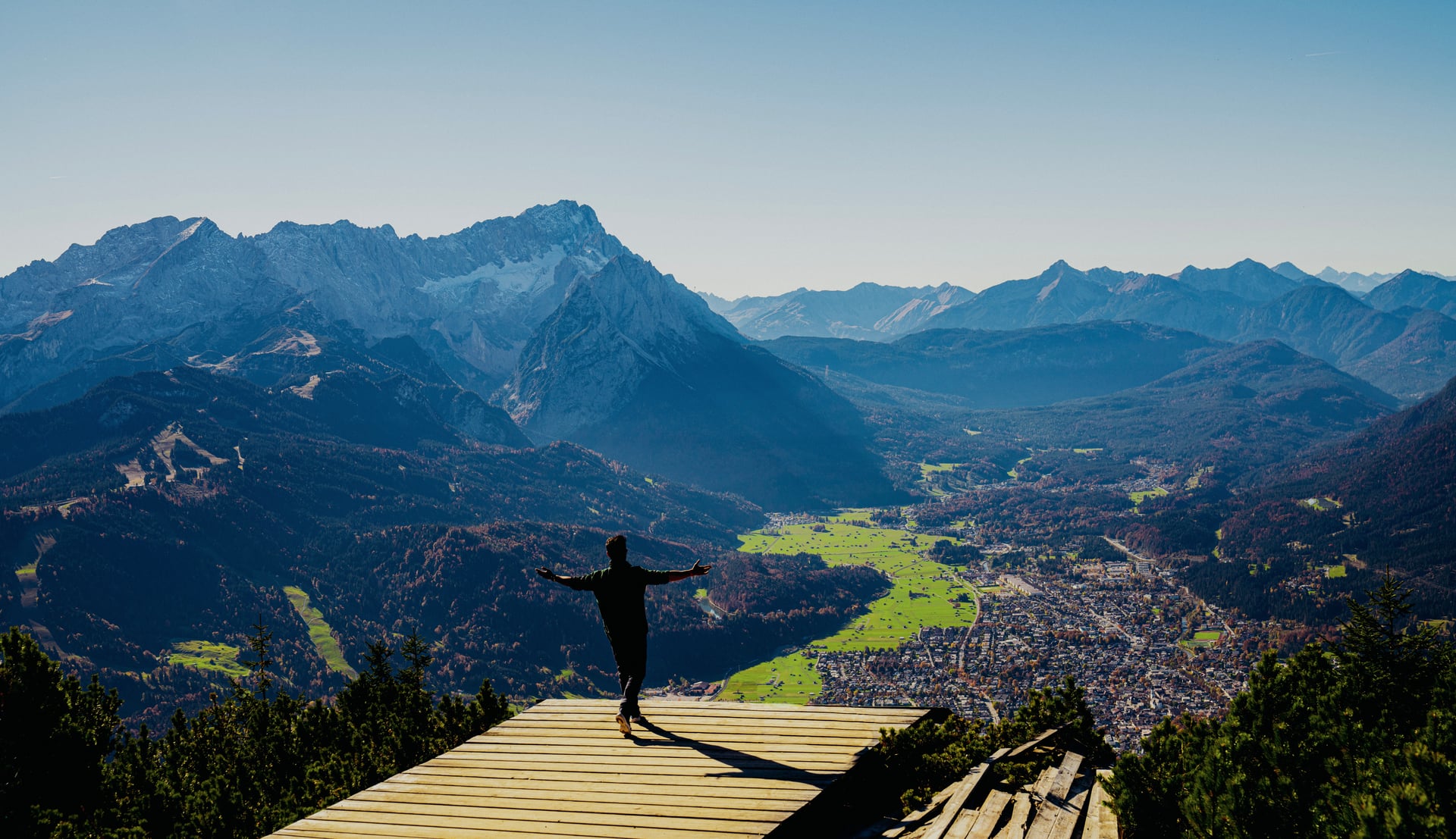 Arms open on a mountain viewpoint over Garmisch